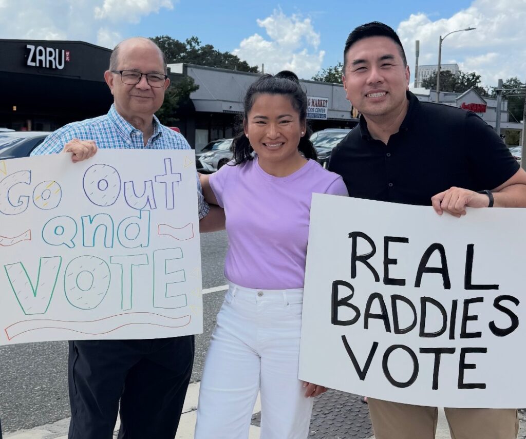 Kam Shenai (left) standing with his fellow co-founders, Onchantho Am (middle) and Ricky Ly (right), on East Colonial Drive on National Voter Registration Day.